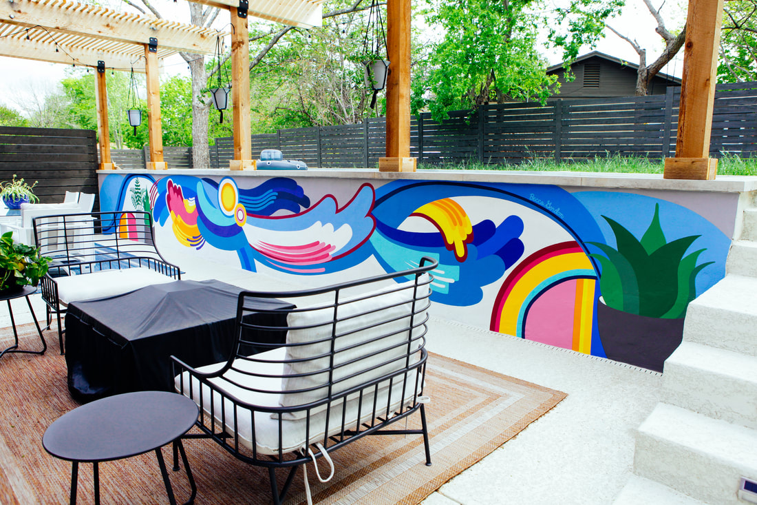 Colorful outdoor pop art mural by Becca Gordon next to a backyard pool
