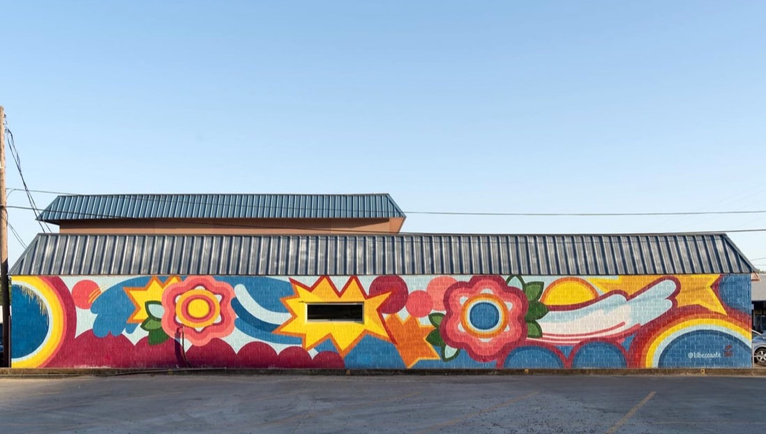 Large outdoor pop art mural with flowers in San Marcos, Texas